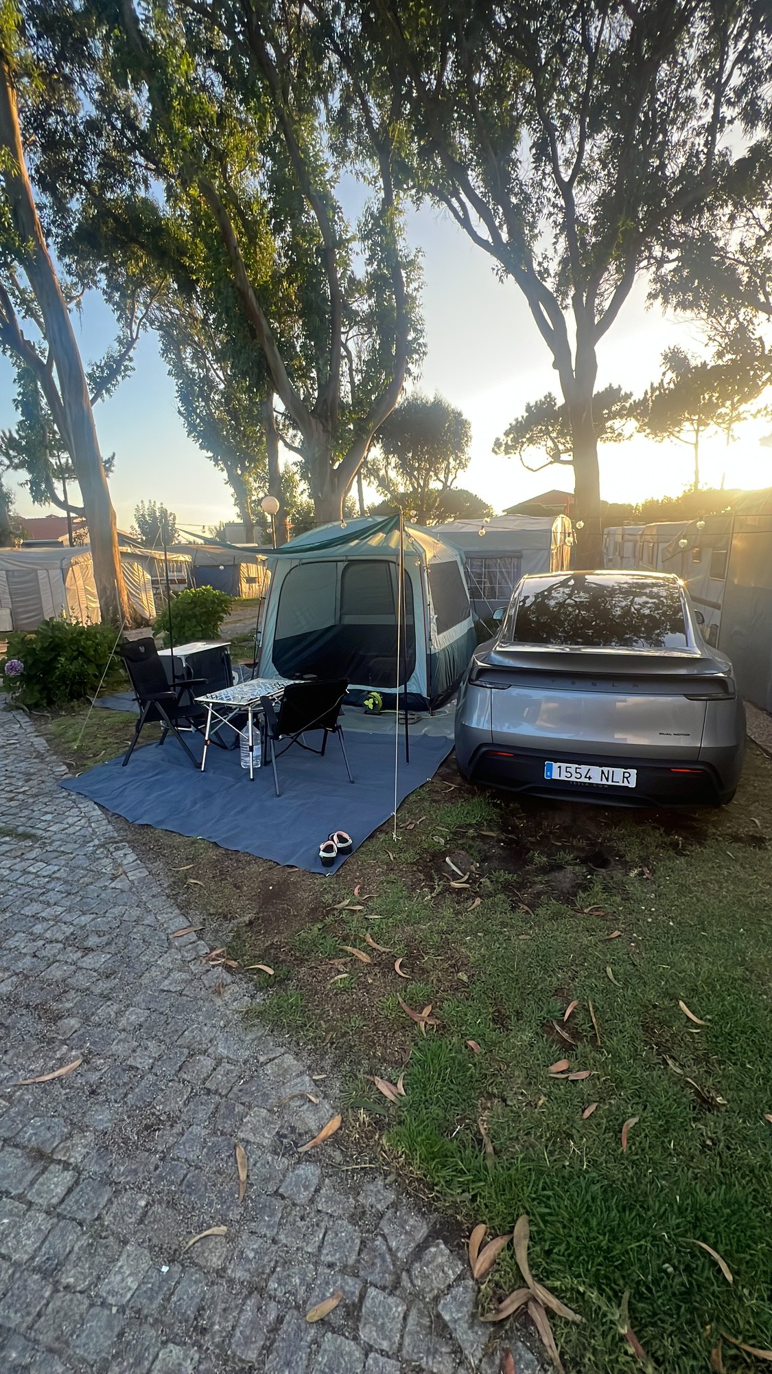 Home for the night: tent, Tesla, trees. The beach is right there. Porto is a 30-minute local train away. This is our idea of a commute.