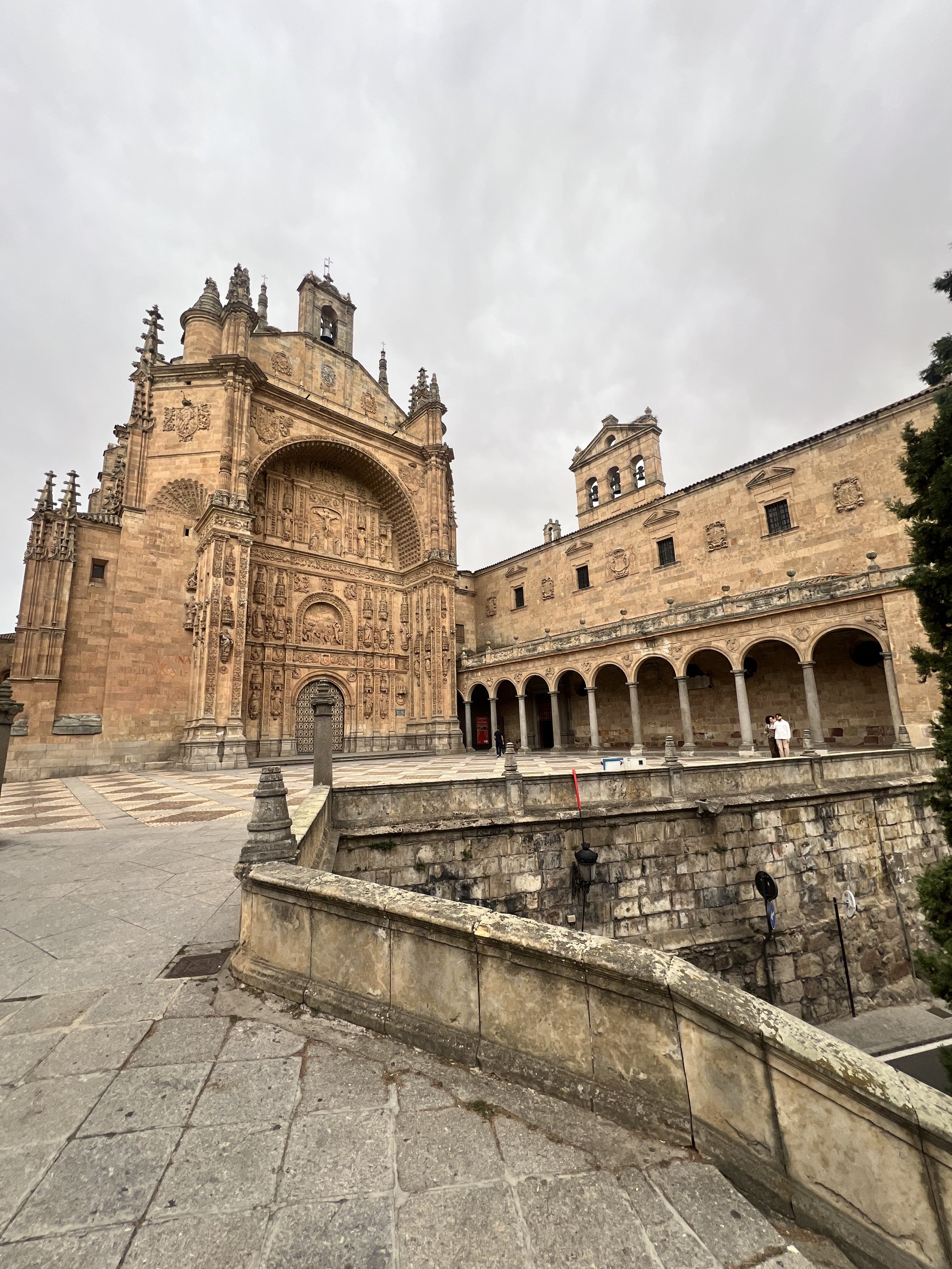 San Esteban doing the carved-sandstone thing. Courtyard, portico, sky still on strike.