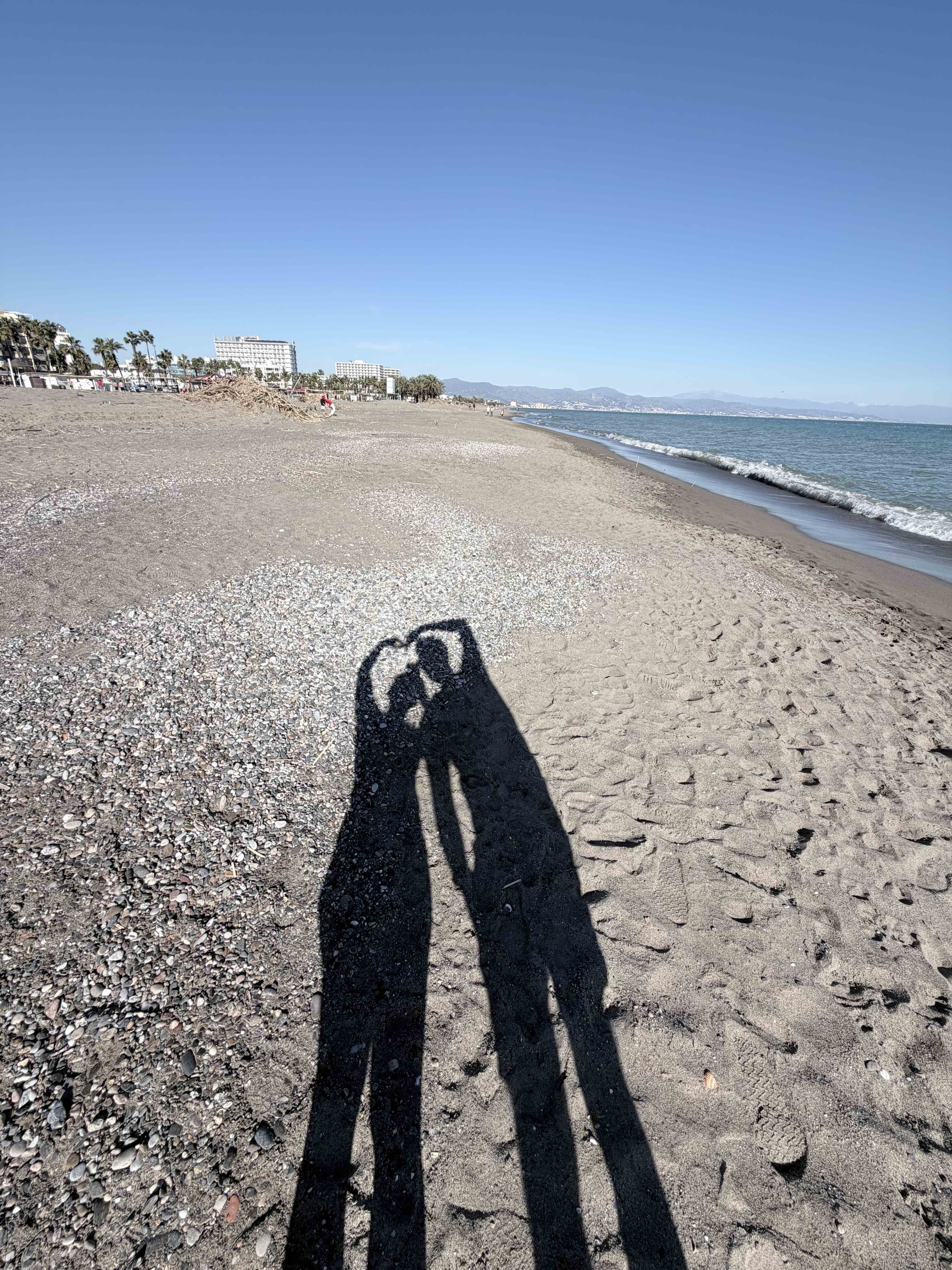 The beach and promenade in Torremolinos on a clear winter day.